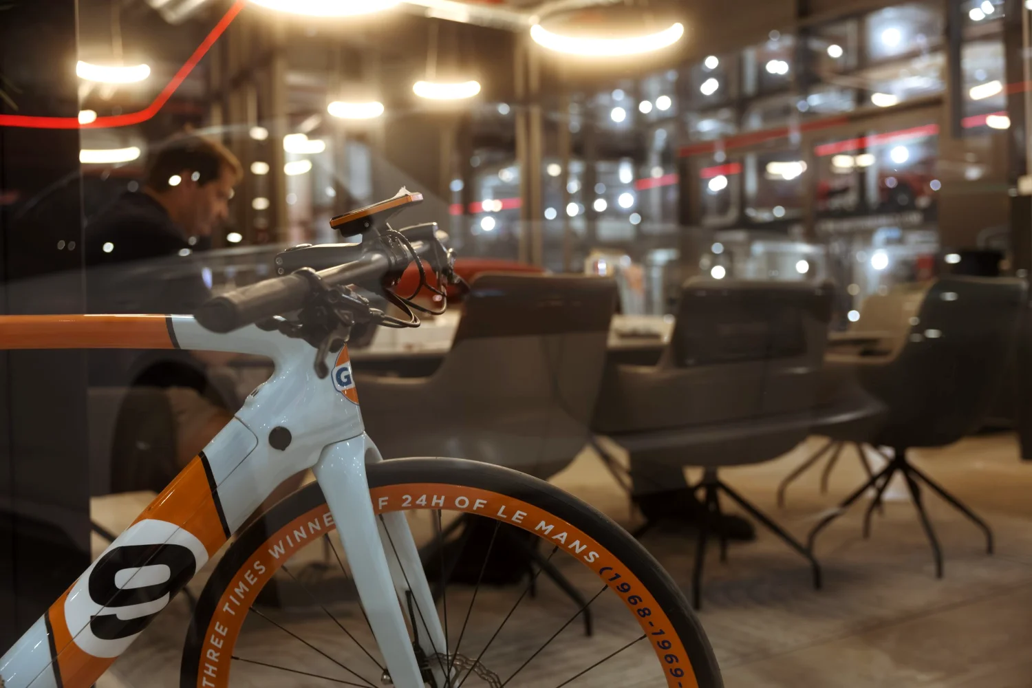 A premium showroom bike on display behind glass at Motorworld